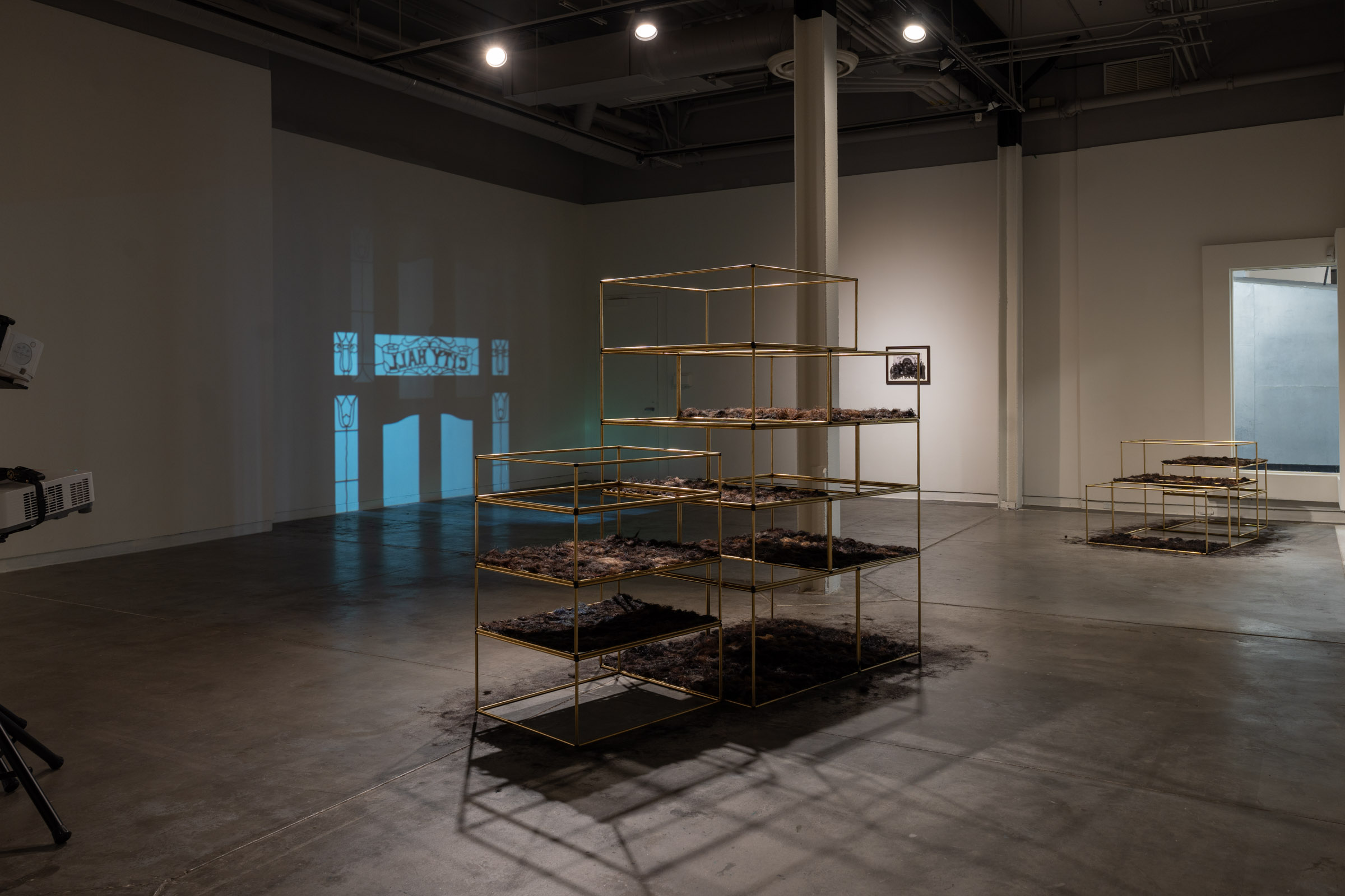 Installed view showing sculptural structures and immersive projection mapping
