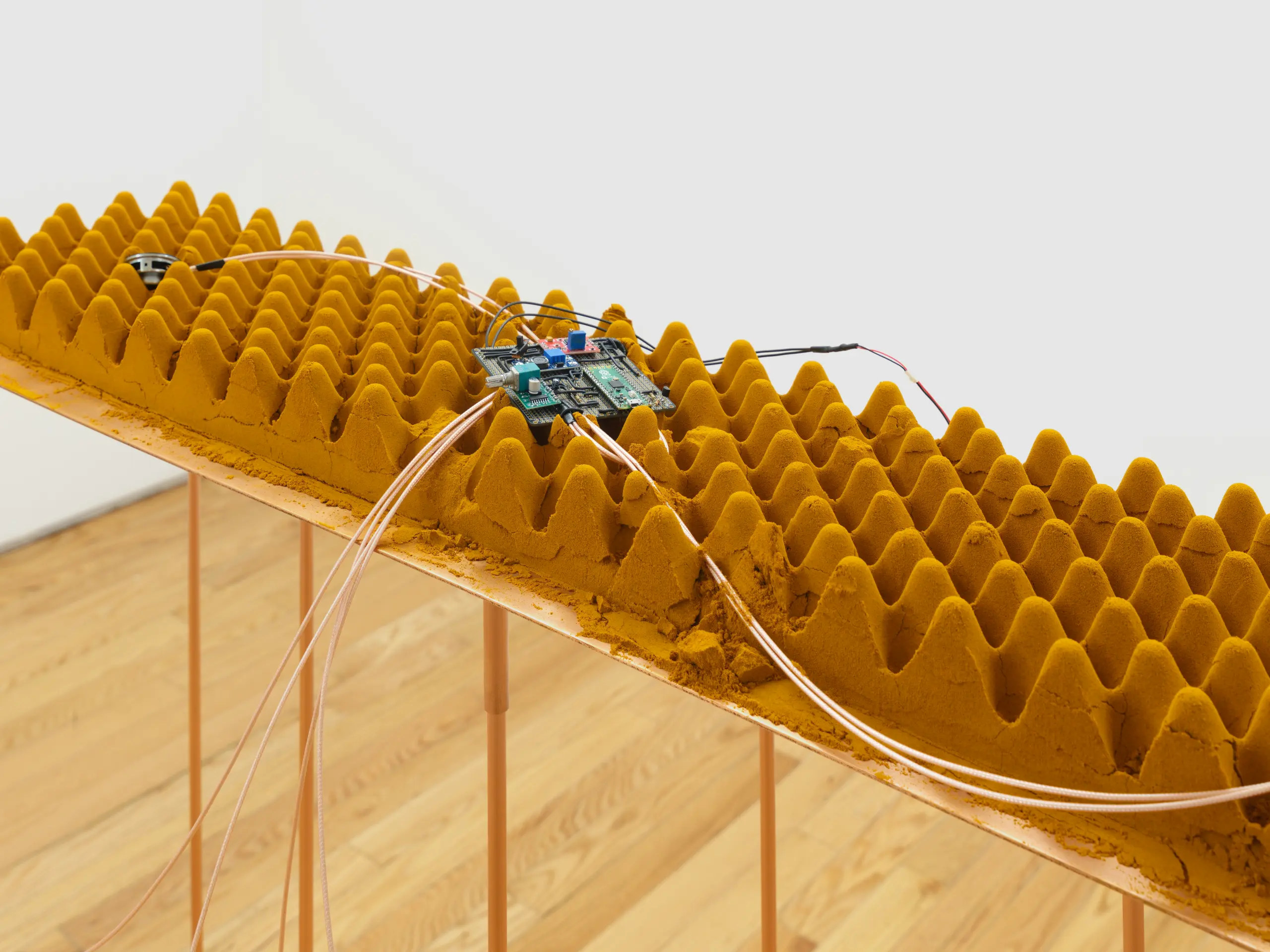Detail of interactive sound piece showing circuit board, copper wiring, and turmeric powder cast